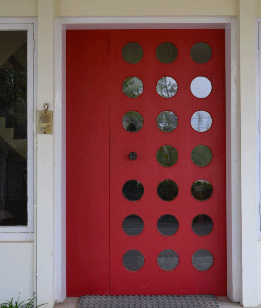 A striking red, retro front door in a Karachi home. 